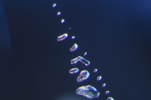 A string of negative crystals decorates the interior of this untreated sapphire. Negative crystals can be identified by the fact that similar faces will all reflect light at exactly the same time.