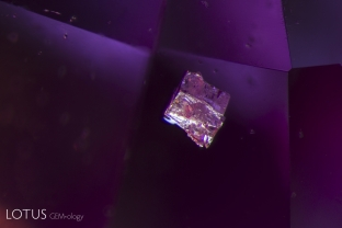 Madagascar sapphires often contain zircon crystals. More typically we see them in rounded, oval forms, but occasionally we find an example of a blocky zircon crystal like this one.