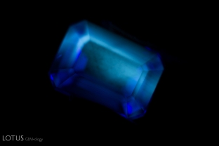 A strong chalky fluorescence can be observed in this titanium-diffused synthetic sapphire.