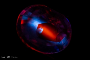 This heated pink sapphire displayed a bold chalky angular zoning pattern interspersed with its strong red fluorescence when observed in shortwave illumination.