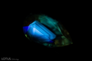 An angular zoned chalky fluorescent patch can be easily spotted when this heat-treated sapphire is observed in shortwave illumination.